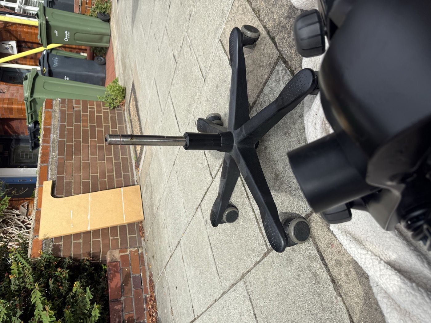 Old gas lift being removed from an office chair five-star base during an on-site repair