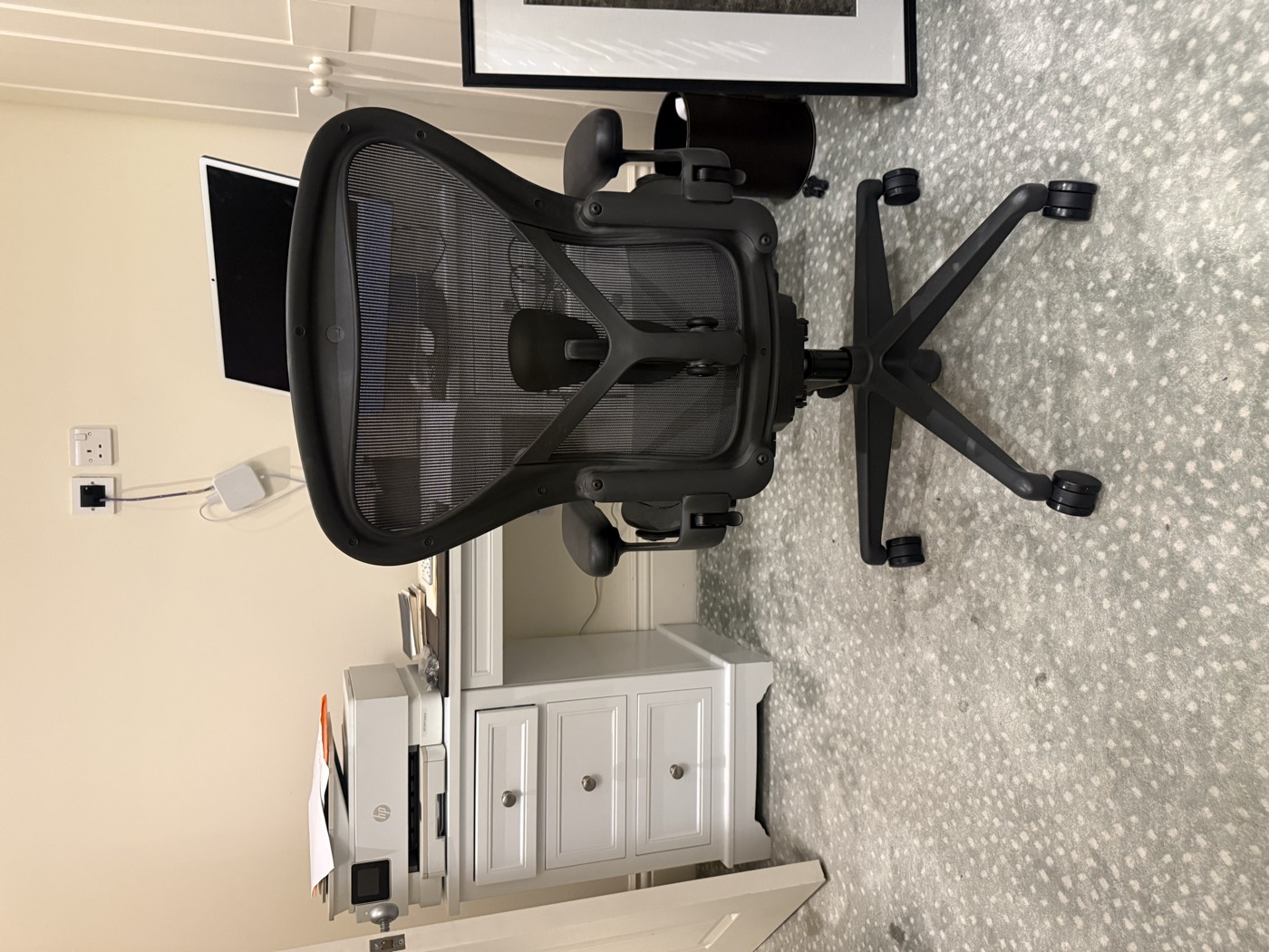 Repaired Herman Miller Aeron chair back at a home office desk